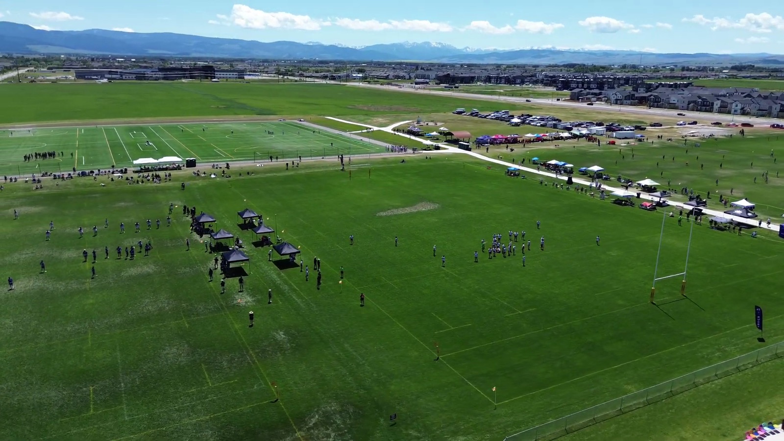 Aerial view of the Bozeman Sports Park fields with the mountains behind