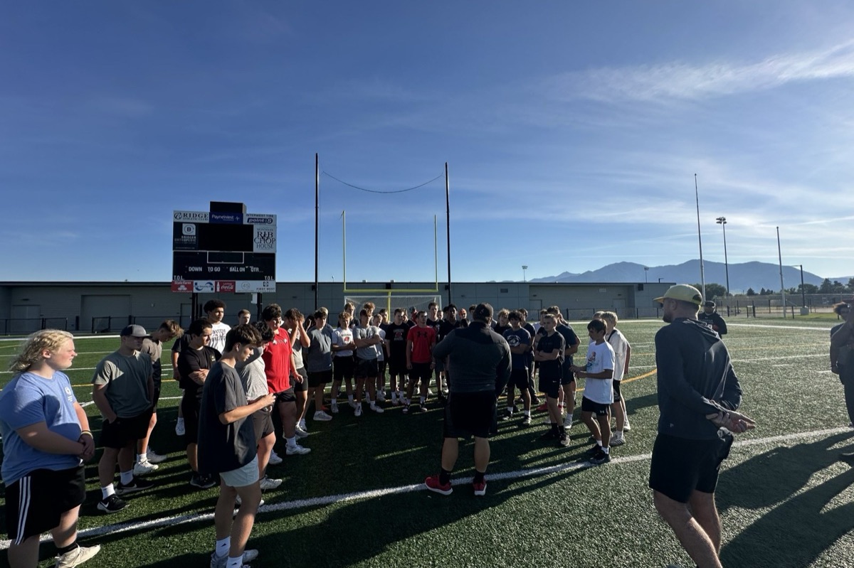 Coaches and athletes gathered on the field at a Bozeman clinic